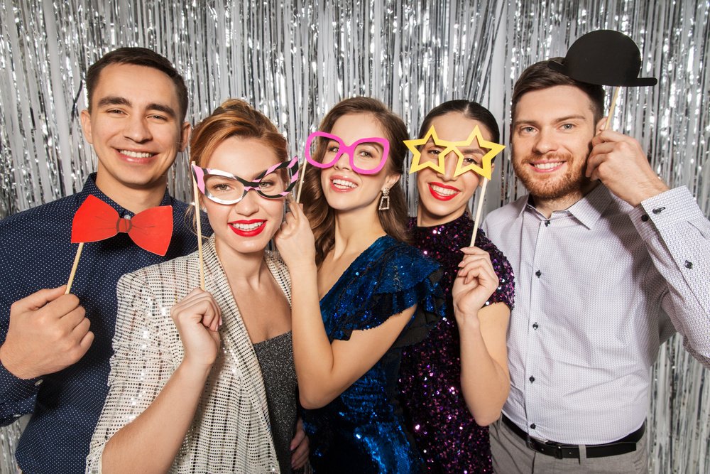 happy friends posing with party props